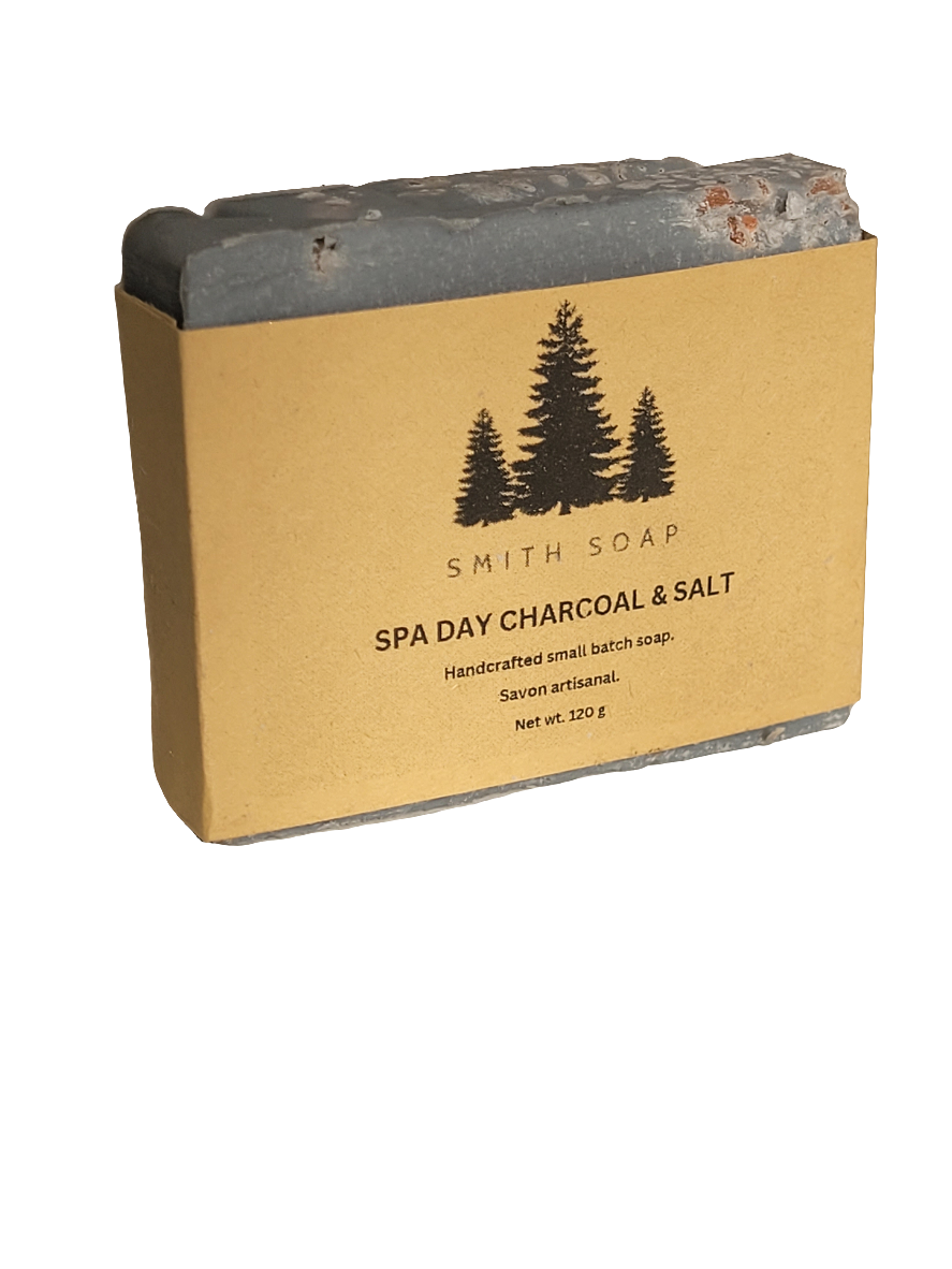 A charcoal grey bar of soap with oink salt crystals decorating the top. Wrapped in a craft label.