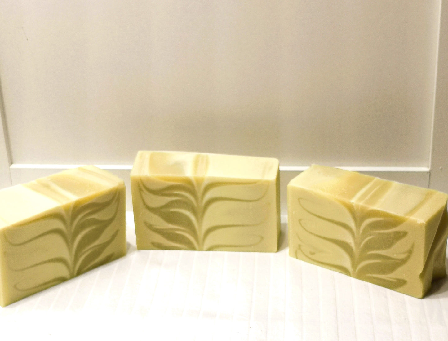 three bars of natural soap with lotus design