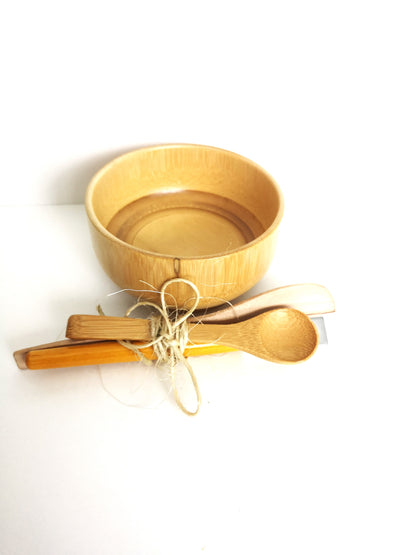 One bamboo bowl with bamboo mixing spoon, spatula and brush tied in a bundle with sissal twine. 